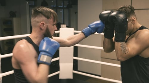 Two Boxers Training Punches and Defense