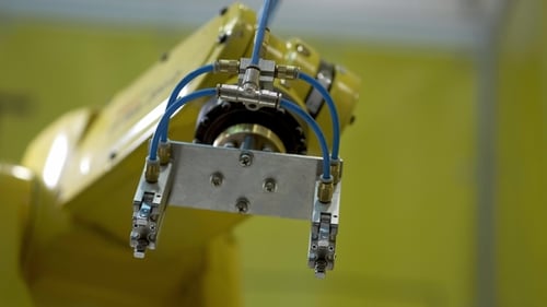 Yellow Industrial Robot Manipulator Performs Movements That Are Programmed in the Control Unit
