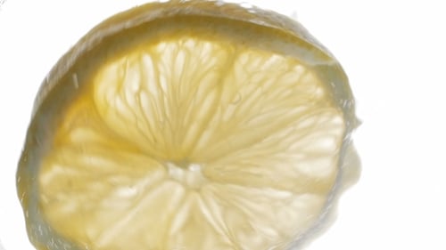 Lemon Slice in Clear Water with Bubbles