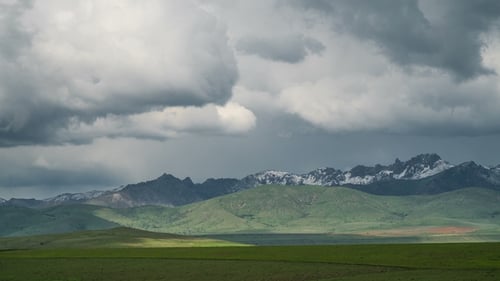 Sky with Clouds Over Beautiful Valley Between the Mountains and Green Meadow