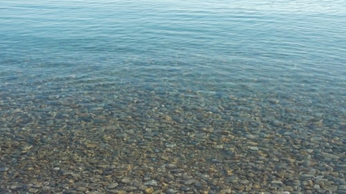 Crystal Clear Sea Water over Rocky Seabed