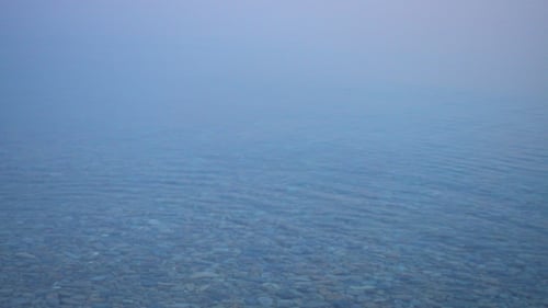 Water Ripples Across Pebbles on a Lake