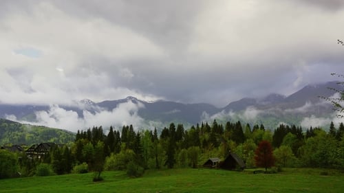 Mountain Alps House and Trees in Fog Clouds