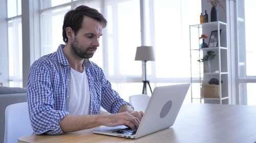Casual Beard Man Working On Laptop in Office,