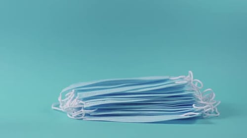 Protective masks dropping on white table