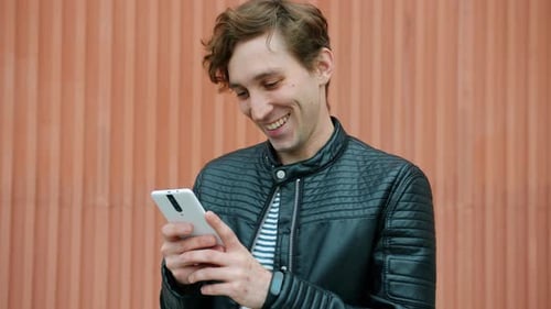 Man Using Smartphone Reacts to Good News