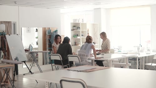 Fashion Designers in Small Business Startup Company Sit in the Atelier at Their Desk and Do Business