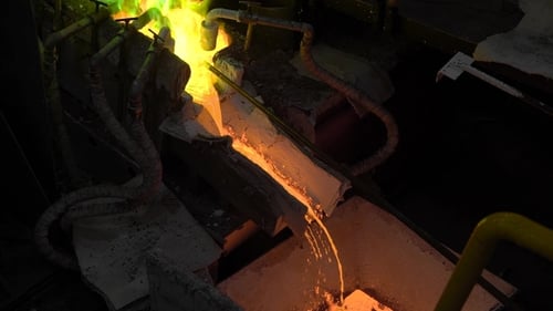 Glowing Molten Metal Pouring in Dark Factory