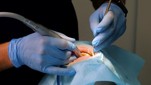 Dentist Using Drill During Dental Procedure