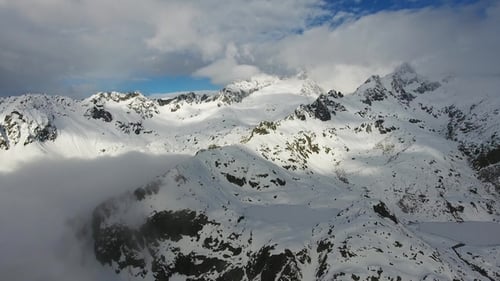 Snow-capped Mountains in Clouds