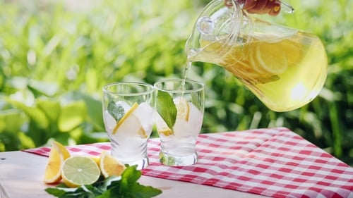 Refreshing Lemonade Being Poured into Glasses