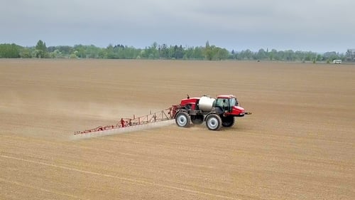 Tractor Sprays Large Field From Above