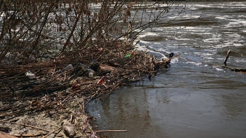 Polluted River with Plastic Waste and Dirty Water