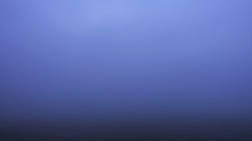 Beautiful Sunrise over Lake on Foggy Morning