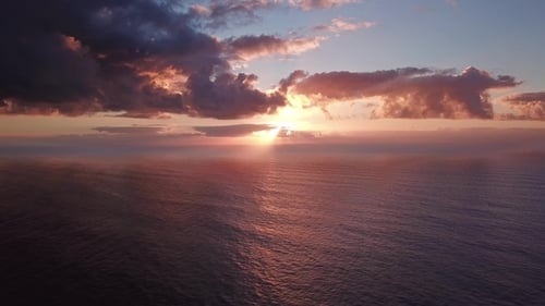 Flying To Setting Sun Over Atlantic Ocean