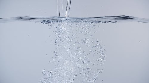 Water Pouring Into Liquid Causing Bubbles