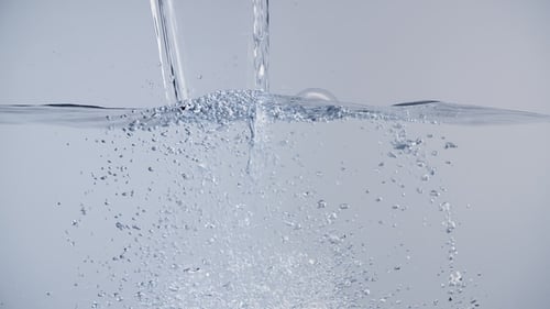 Clear Water Pouring Creates Bubbles And Splash
