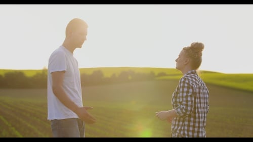 Farmers Talking While Shaking Hands At Farm