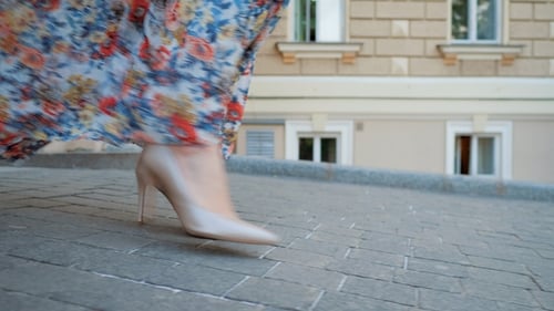 Girl in Beautiful Silk Long Dress. Female Legs in High Heels Shoes Walking in Urban Street