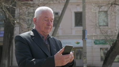 Expirienced Man Seeks Info on His Phone in an Alley in Spring in