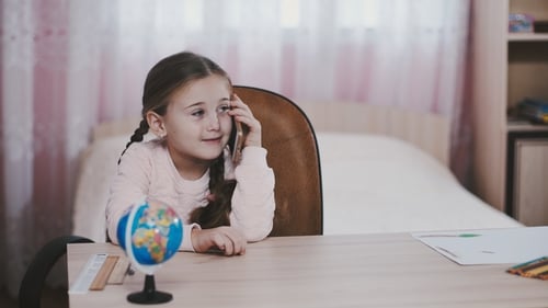 Girl Talking on Phone at Desk in Bedroom