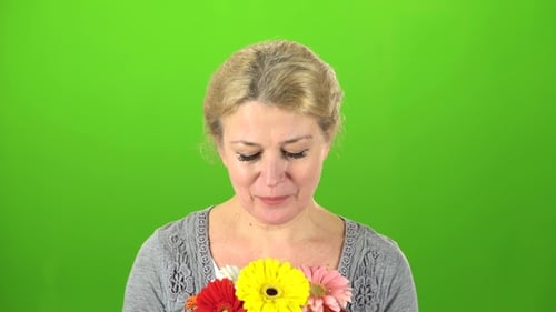 Woman Is Sniffing Flowers
