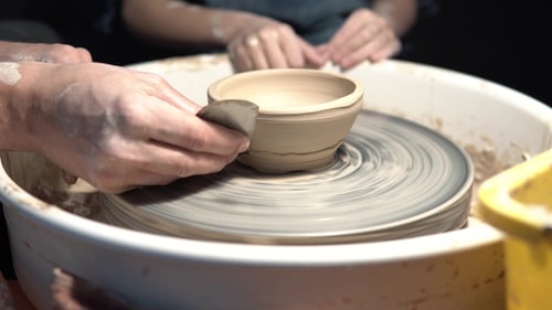 Hands Shaping Clay on a Spinning Pottery Wheel