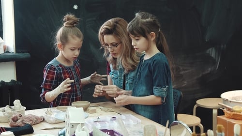 Workshop for Work with Clay. Mom with Two Little Daughters Are Busy Modeling with Clay. Joint