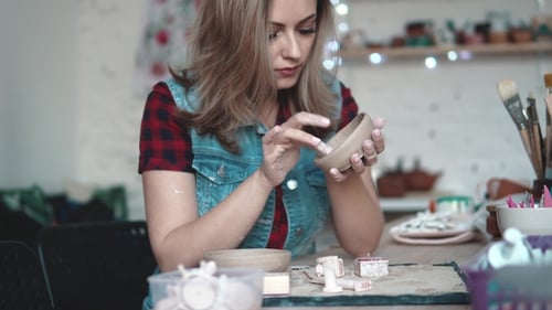 Young Woman Creates a Plate of Clay in the Workshop. Girl Holding a Shape of Clay in Her Hands. the