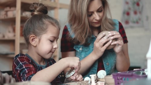 A Little Girl Is Making a Clay Craft in a Pottery Workshop