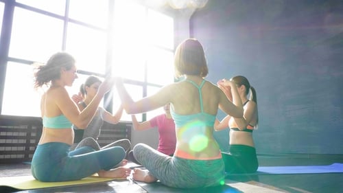 Young Women Doing Yoga Together Indoors
