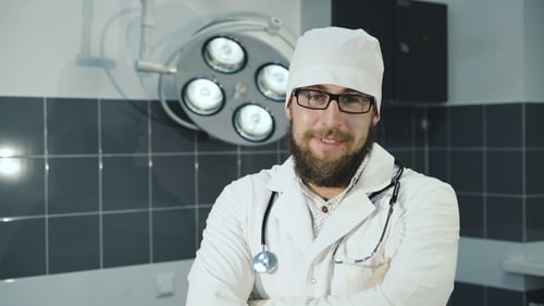 Doctor Smiling in Exam Room with Medical Lighting