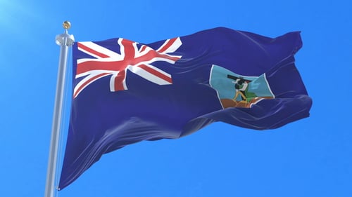 Montserrat National Flag Waving in Realistic Blue Sky