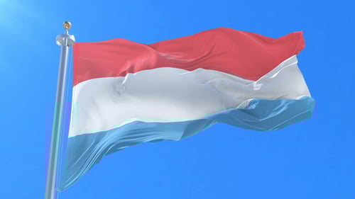 Luxembourg Flag Waving Against Blue Sky