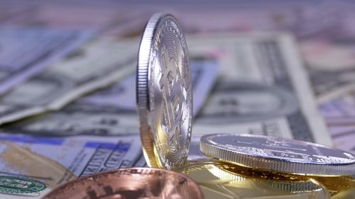 Close Up of Silver Bitcoin on US Currency
