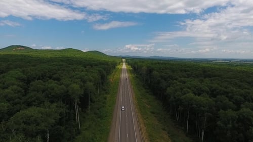 Aerial View Above Cars Driving Along Empty Countryside Road on Sunny Day