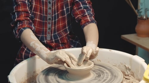 Serious Little Girl Being Concentrated on Making a Clay Ware on a Pottery Wheel