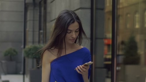 Young Women Chatting with Shopping Bag and Phone
