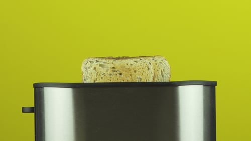 Toast Pops From Toaster Against Yellow Background