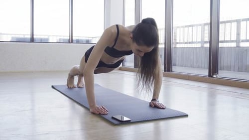 Woman Doing Pushups on Exercise Mat Indoors