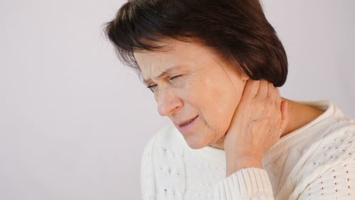 Senior Woman Massaging Her Neck Due to Pain