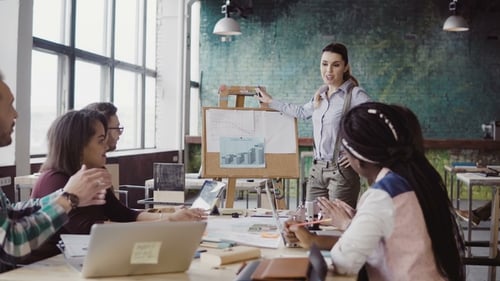 Meeting of Mixed Race Business Team at Loft Office. Woman Manager Presenting Financial Data, Group
