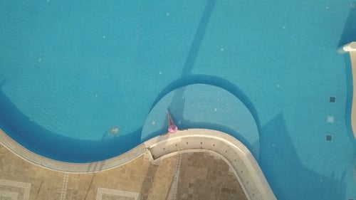 Young Woman Relaxing at Swimming Pool