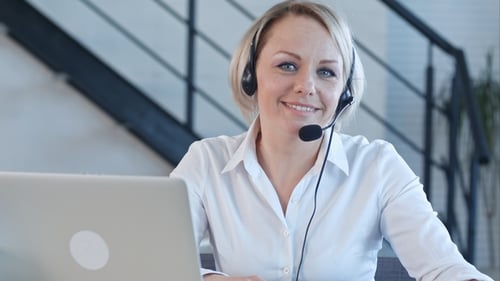 Beautiful Business Customer Service Woman Smiling Talking To a Camera in the Call Center