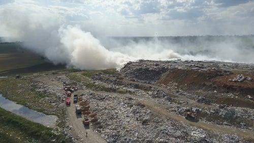 Garbage Dump Pollutes the Environment. Strong Wind Rises Toxic Smoke of Burning Garbage Into the Air