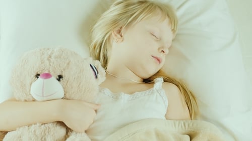 Child Sleeping Soundly with Teddy Bear
