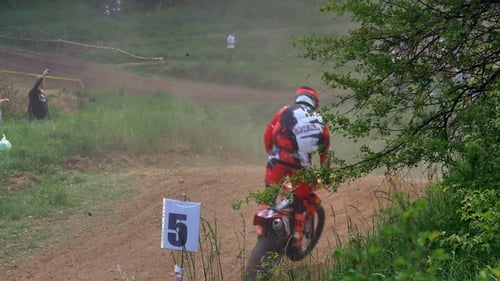 Motocross Racers Speeding Down Dirt Track