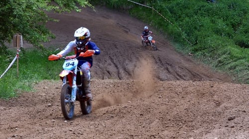 Dirt Bikes Racing on a Muddy Track