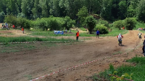Motocross Riders Racing on Rural Dirt Track