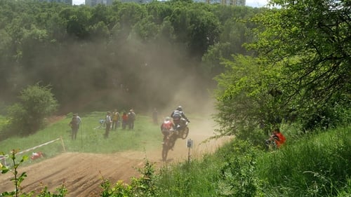 Motocross Racers Jump Over Dirt Hill
